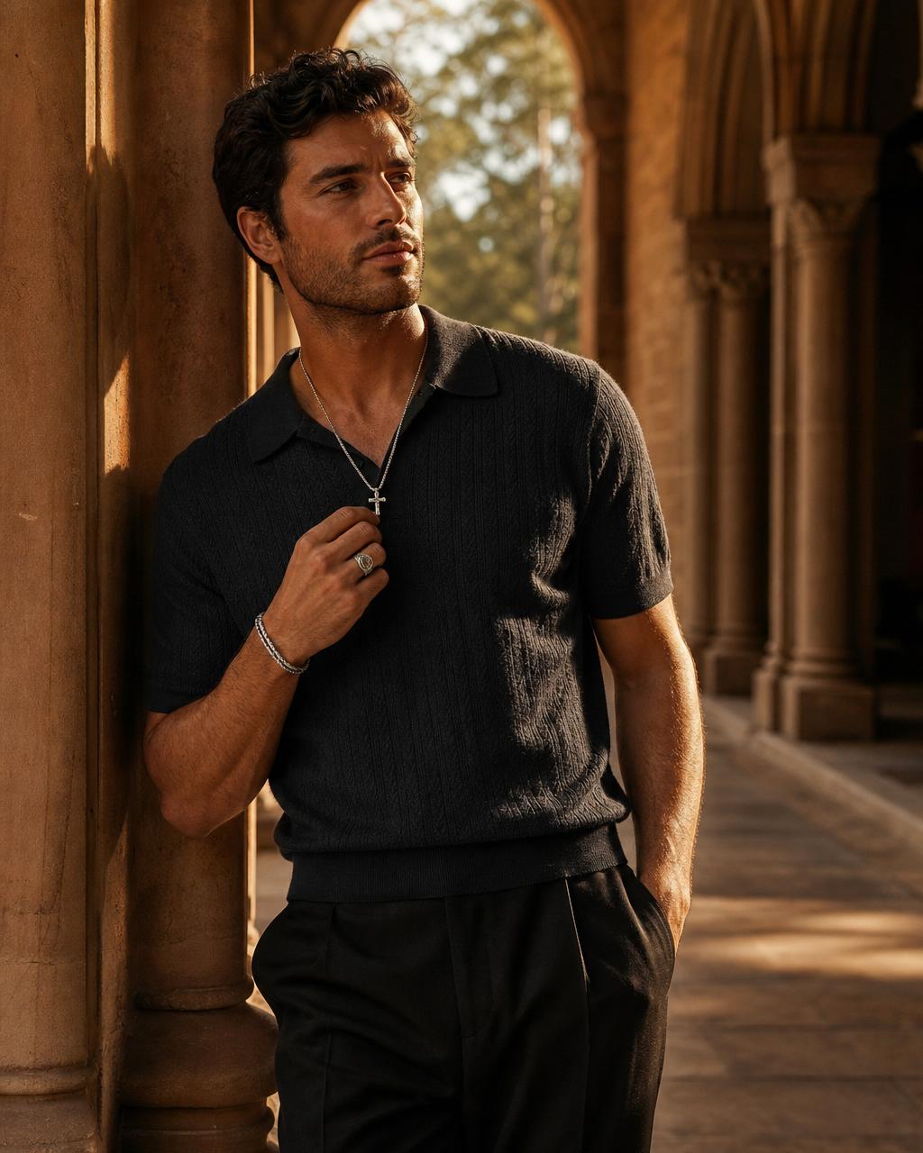 God Inc Strength — male model in silver cross necklace on sandstone cathedral steps at golden hour.